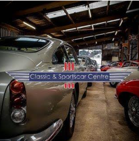 Classic and Sportscar Centre showroom with an Aston Martin DB and Jaguar E-Type among vintage cars