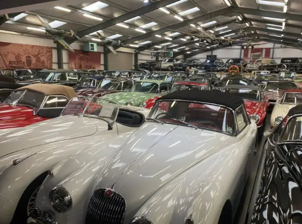 Warehouse full of classic Jaguar XK convertibles at a marque specialist