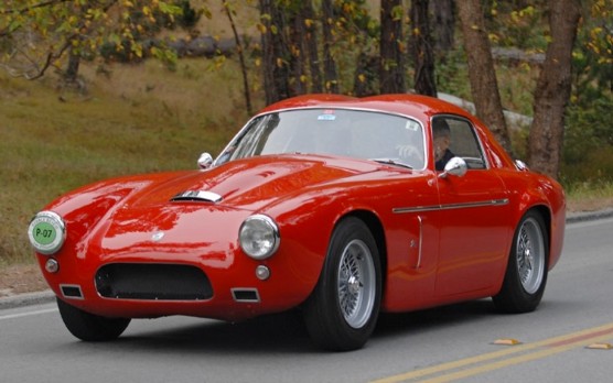 Red Zagato-bodied AC Ace-Bristol coupé with double-bubble roof on a road