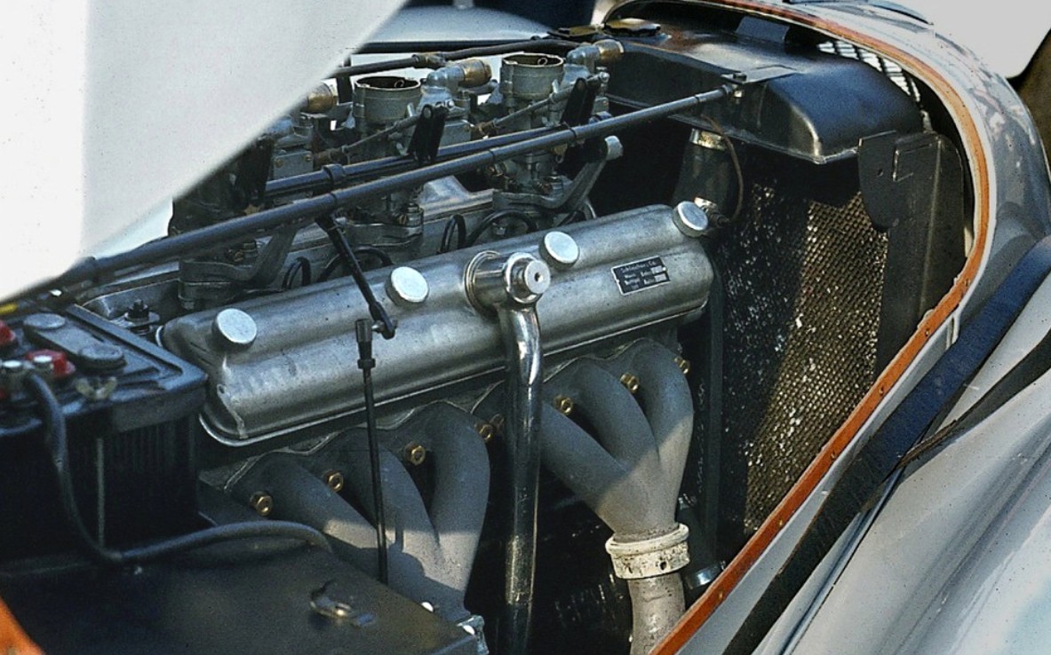 Bristol two-litre six engine bay showing the polished twin rocker covers, triple downdraught carburettors and tubular exhaust manifold