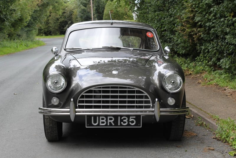 Head-on view of UBR 135 showing the AC Aceca's slender egg-crate grille, faired headlamps and chrome twin-tube bumper