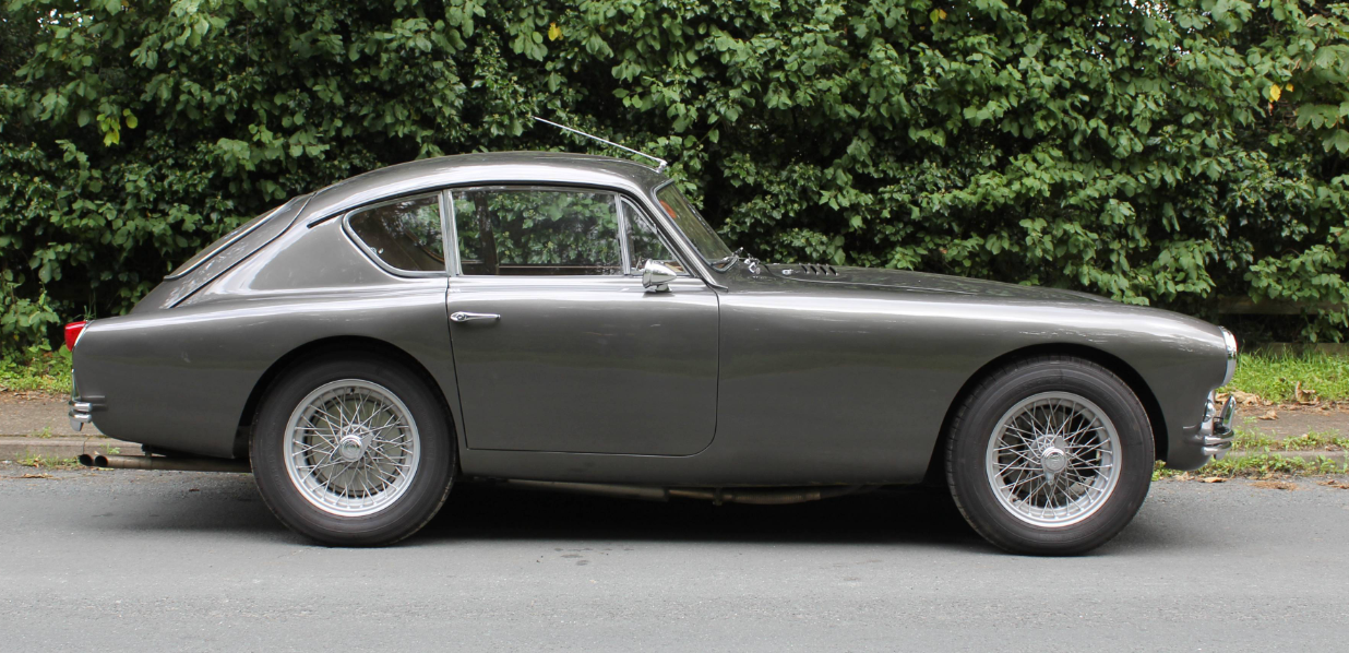 Grey AC Aceca-Bristol coupé, side profile, parked in front of a hedge