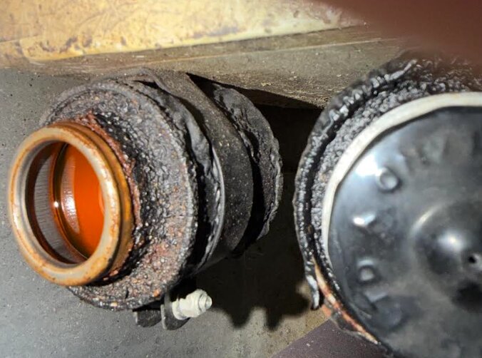 AC Aceca brake fluid reservoir with the cap removed, showing the amber fluid inside