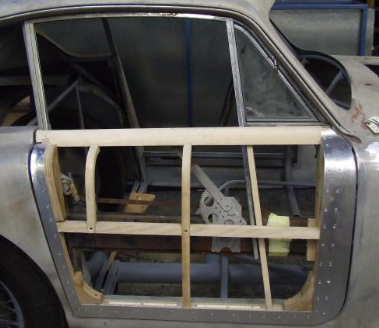 Aceca door aperture during restoration showing the ash timber frame beneath the aluminium coachwork