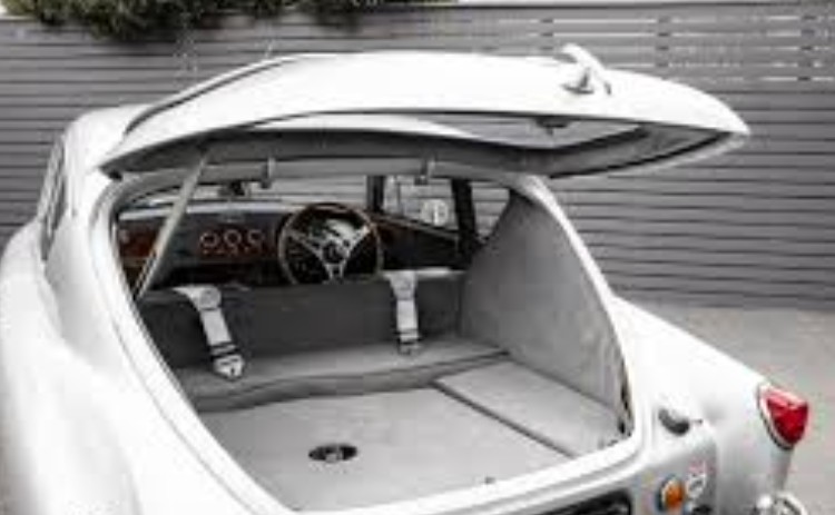 AC Aceca with its lift-up hatchback tailgate open, revealing the carpeted luggage area beneath the fastback roofline