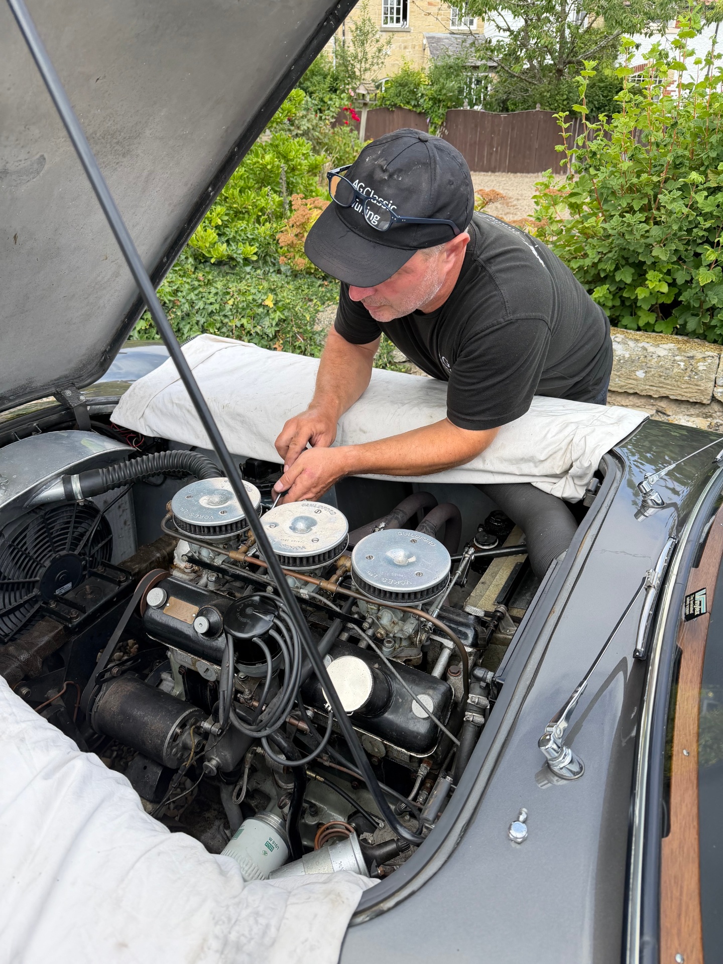Andrew Grabowski of AG Classic Car Tuning working on a triple-carburettor engine