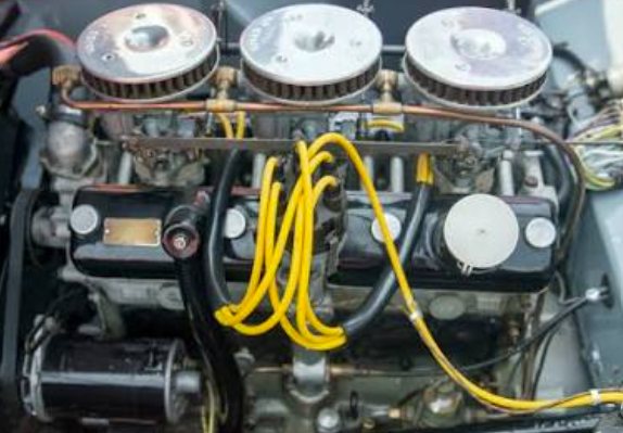 Three Solex B32 PBI-6 downdraught carburettors mounted on the Bristol engine, linked by a common throttle shaft with yellow spark plug leads