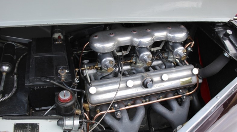 Top-down view of a Bristol two-litre six engine with polished components and triple SU carburettors